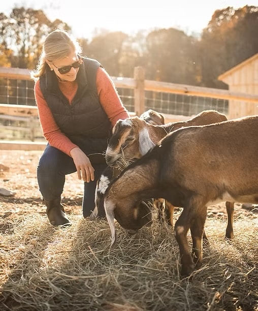 Guest with animals at Blue Iris Farm